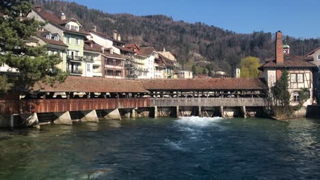 view of an old covered bridge in an authentic village in switzerland