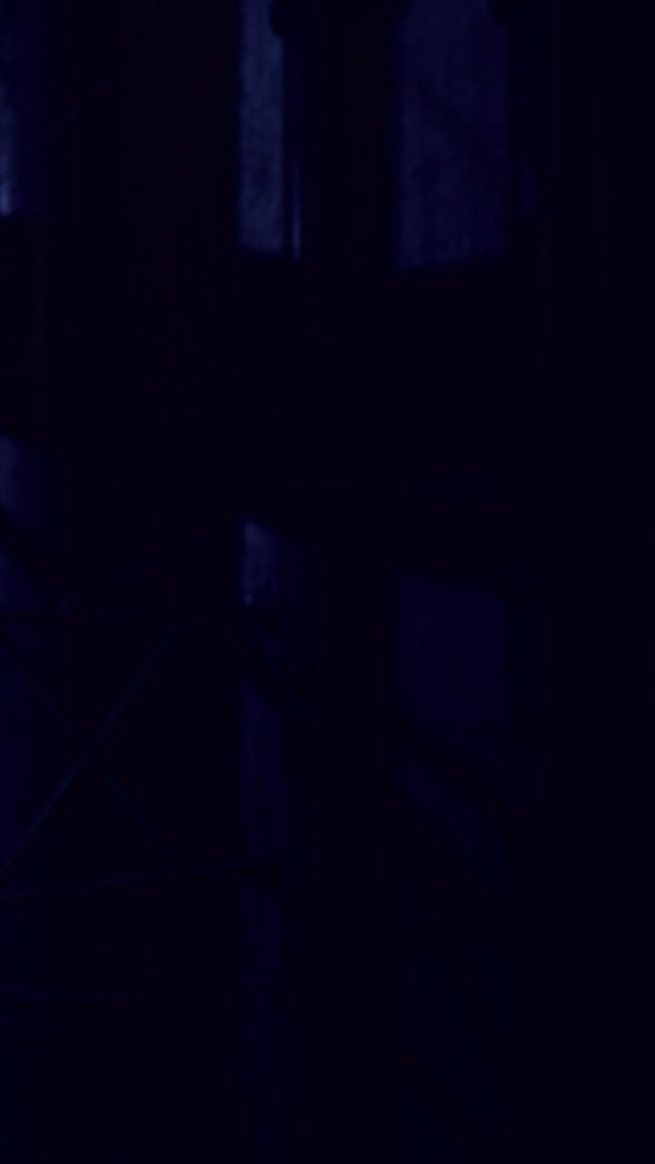 Dark hallway with shadows and light in a building at night
