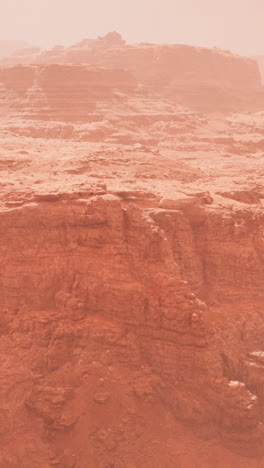 a red desert canyon with a foggy atmosphere