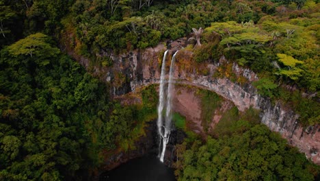 4k aerial view of tropical waterfall in jungle and flying brids