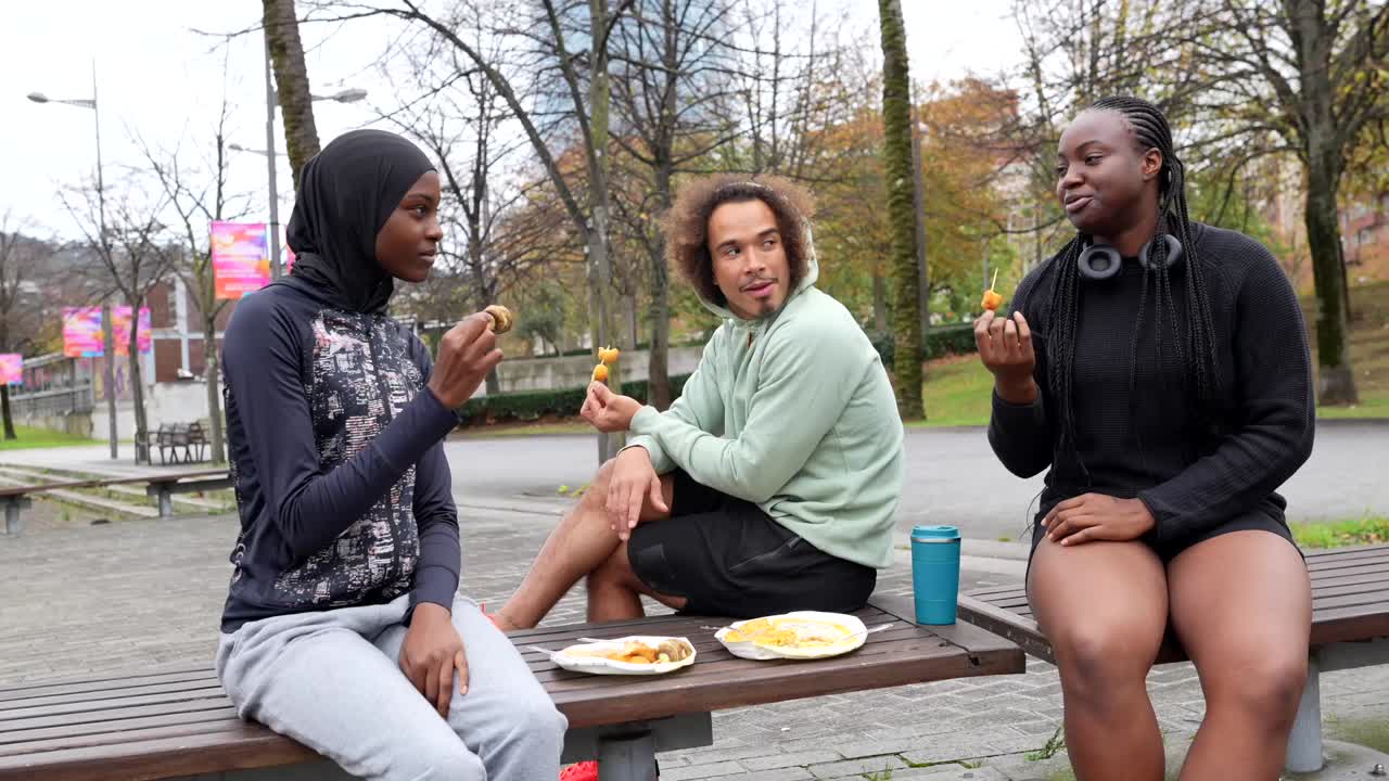Group of Friends Eating Snacks in a Park
