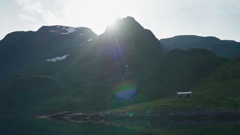 structure on a mountain ridges backlit bright sunlight during winter in norway. - wide shot