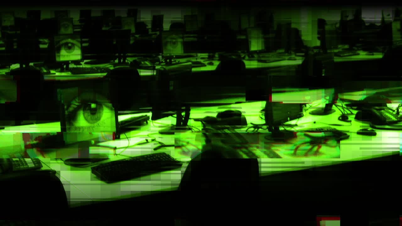 Glitchy panning CCTV footage of a huge room of computers with large eyes on the monitors; surveillance, big brother, watching you, control, paranoia