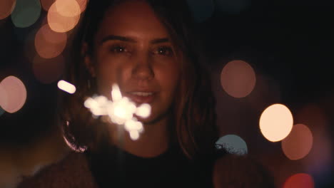 close up sparkler beauitful young woman celebrating new years eve party at night