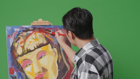 artist painting a colorful abstract portrait