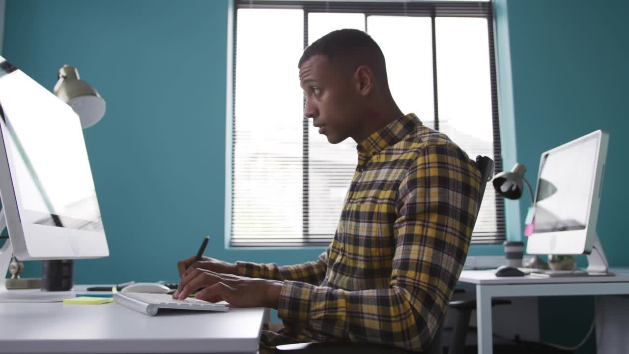 Designer switching stylus and keyboard, overlaying gear and signal icons to refine design on screen