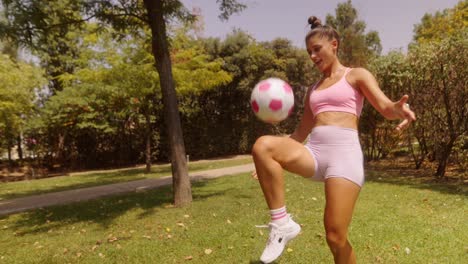 Woman Playing Soccer in Park