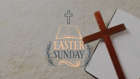 animation of easter sunday text over christian cross and book on grey background