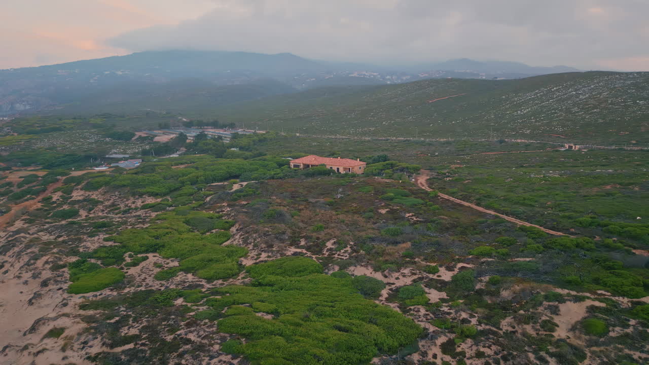 casa solitaria de pie en el valle verde en la mañana nublada de verano. edificio de techo de baldosas