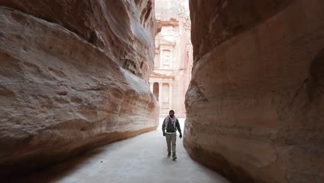 man in petra walking through the siq