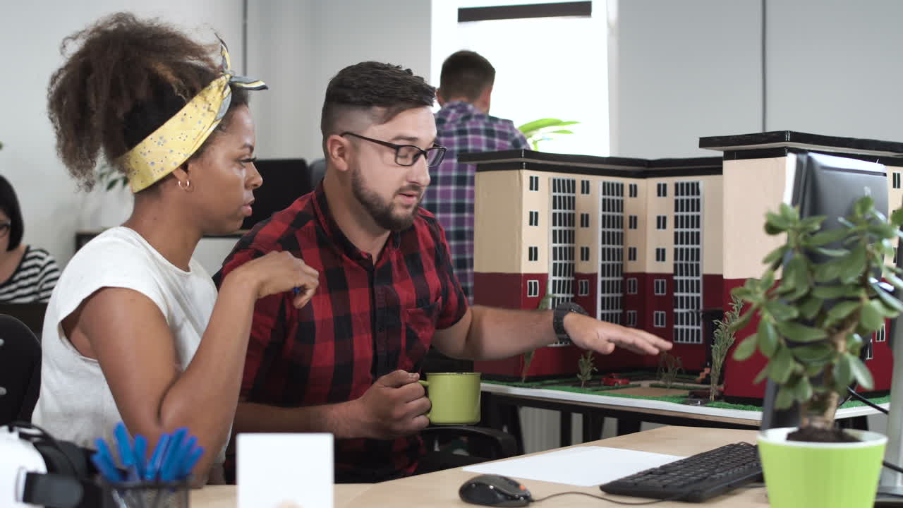 Architects collaborating on a building model