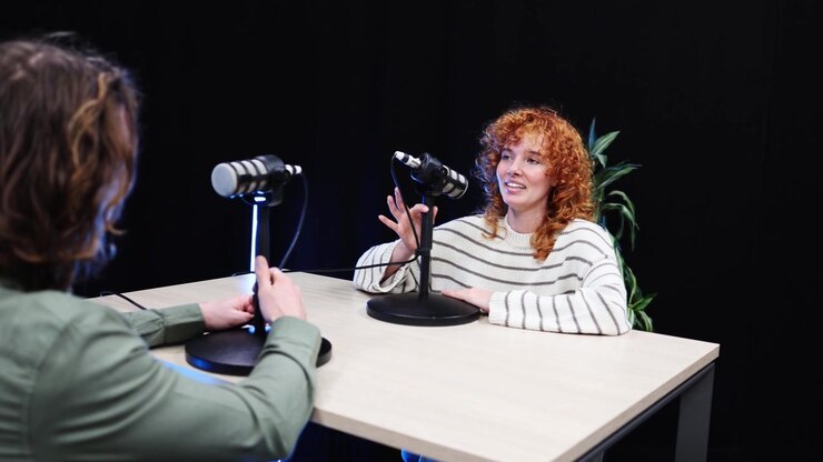 Man and Woman Recording a Podcast Interview in a Studio