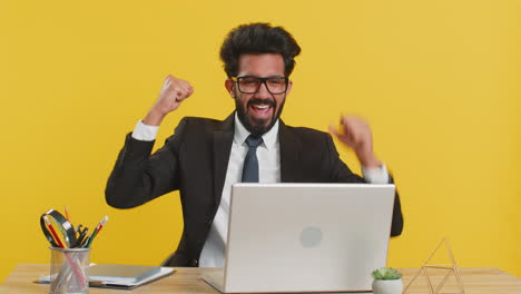 business man winner working browsing typing on laptop at office celebrate big lottery win good news