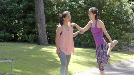 Felices-Amigas-Asiáticas-Estirándose-En-El-Jardín-En-Un-Día-Soleado,-Cámara-Lenta