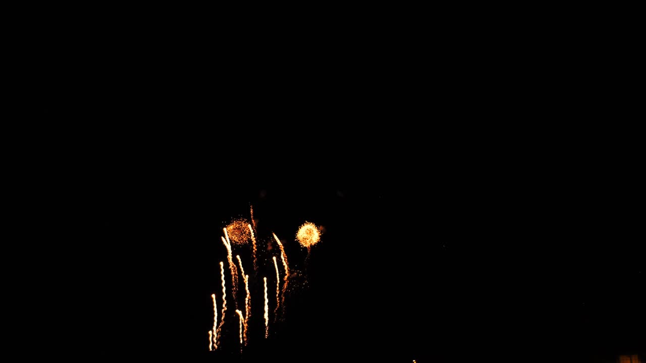 fireworks and streamers illuminate the night sky