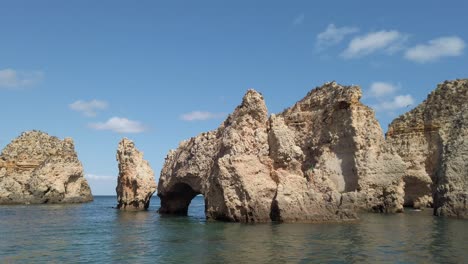 Yellow-limestone-natural-rock-formations-off-shore-Ponta-da-Piedade,-Lagos,-Portugal