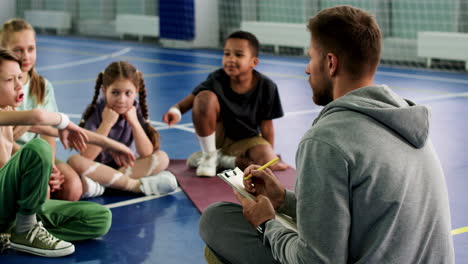 trainer and kids on soccer field