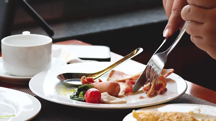 Person eating bacon with coffee in Hanoi