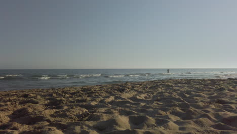 Single-man-fishing-at-the-ocean-on-the-beach