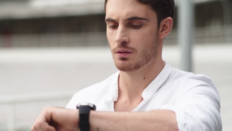 Closeup-guy-checking-time-on-smart-watch-.-Portrait-man-using-digital-watch