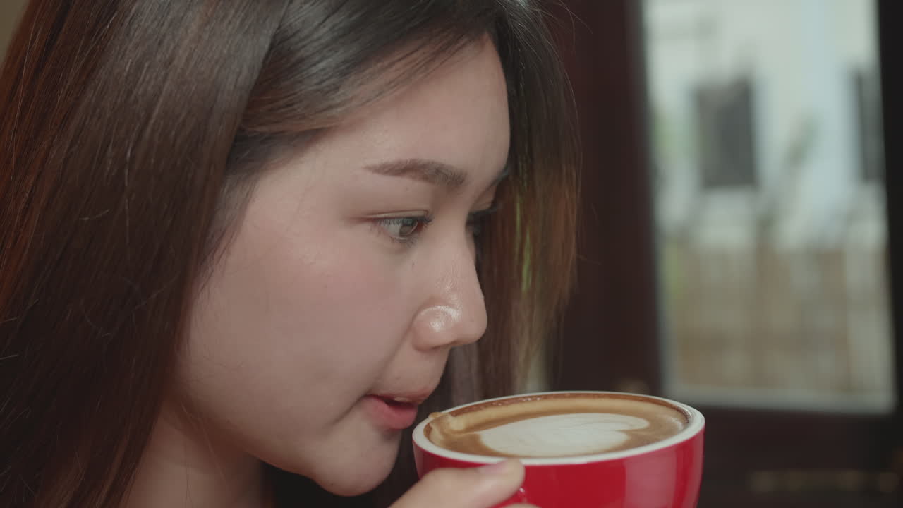 Young Asian Woman Drinking Hot Coffee In Cafe