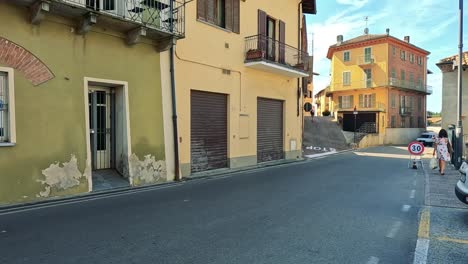 pedestrians and vehicle in a quaint italian street