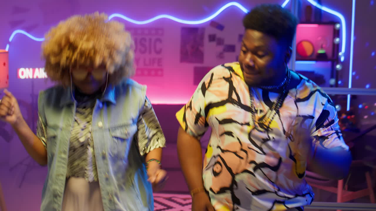 Joyful Black Man and Woman Dancing in Audio Studio