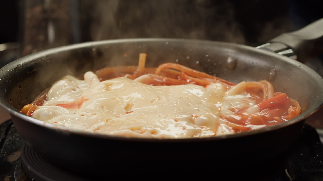 Cooking Pasta with Tomato Sauce and Cheese in a Pan