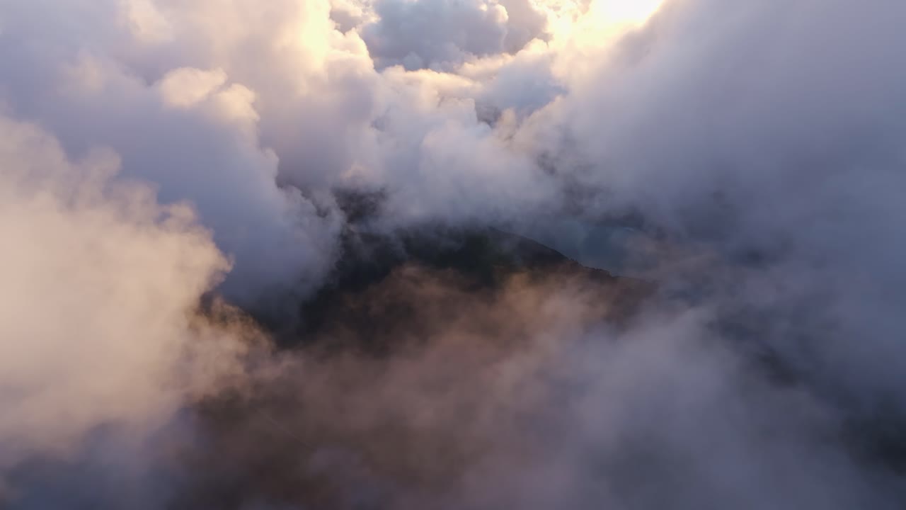 Aerial view of cinematic hikers above the lagoon in Sete Cidades, Azores, surveying over rugged scenery
