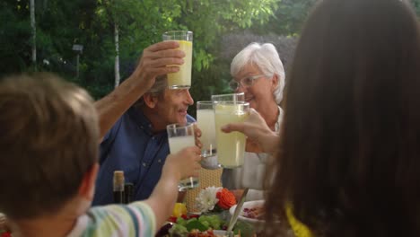 Familia-Comiendo-Afuera-Juntos-En-Verano