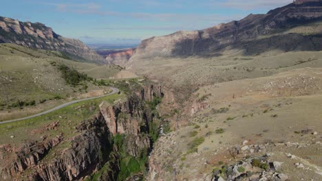 Tracking-aerial-view-of-the-Shell-Creek-canyon-running-beside-route-14-in-Wyoming-on-a-summer-day