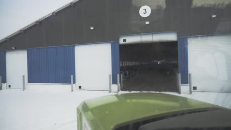 snowy dairy farm building with cows