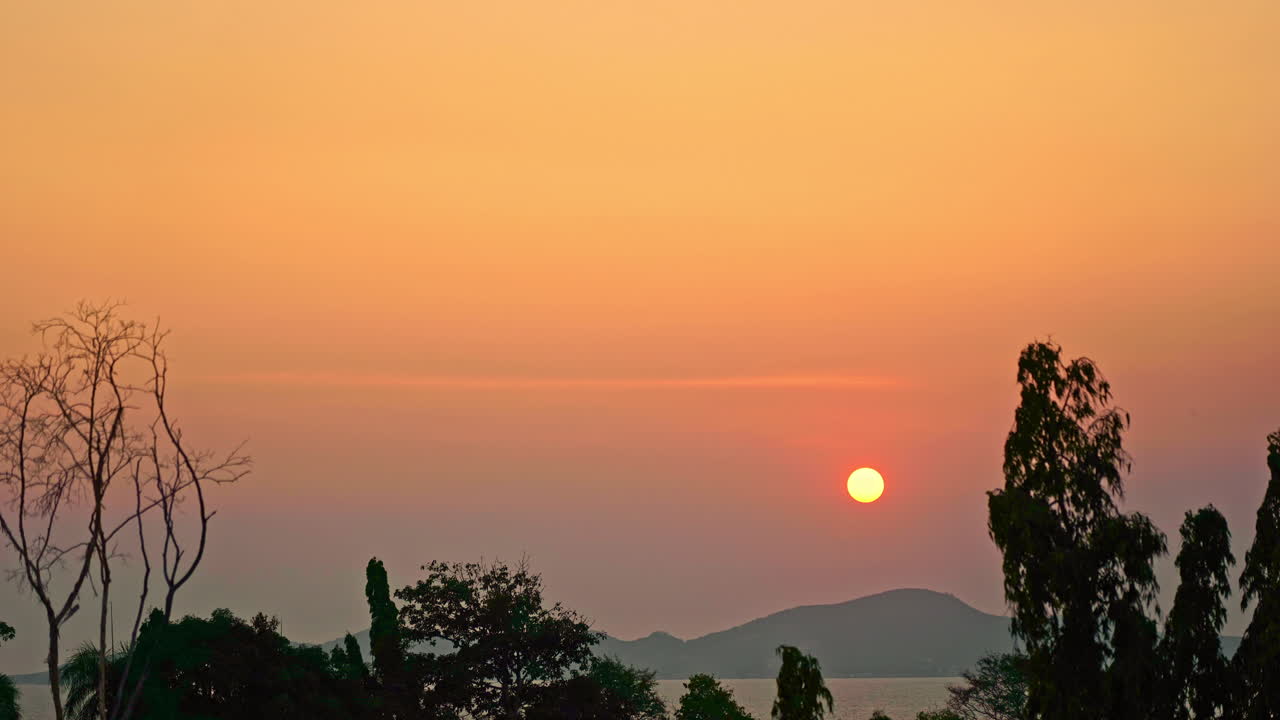 A time-lapse dramatic orange and pink sunset