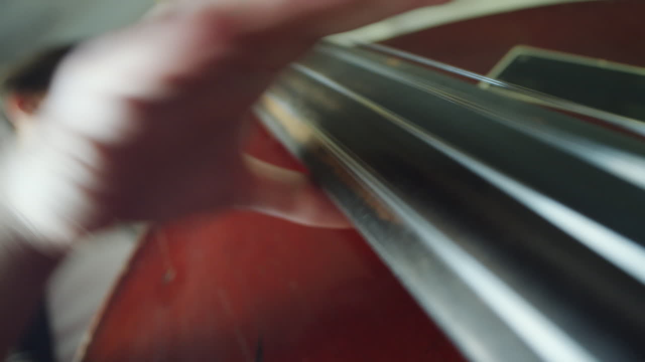 Close-up of a musician's hand playing a string instrument