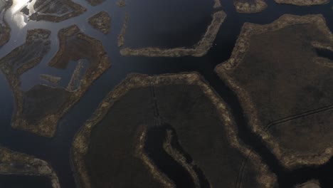 aerial foward shot of weird geometric figures in engures lake