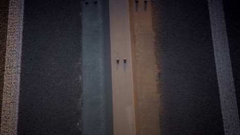 closeup car driving highway in morning. freeway crash barrier view drone shot.