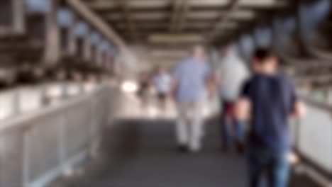 out of focus crod walking under bridge