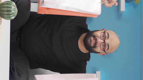 Vertical-video-of-Man-looking-at-camera-with-shopping-bags.