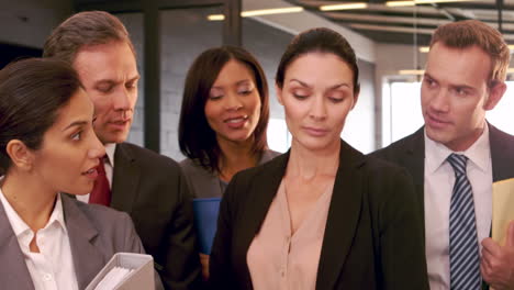 businesswoman showing folders to coworkers