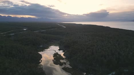 Aerial-Sunrise-Drone-Above-Patagonian-Forest,-Cami-Fagnano-Lake-in-Tolhuin,-Tierra-del-Fuego,-Huge-Landscape-of-Trees-and-Pristine-Water-in-Unpolluted-Area