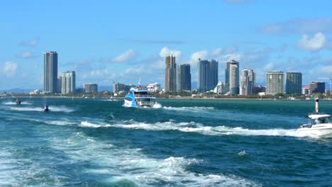 Exciting-action-of-a-speed-boat-bouncing-over-boat-wakes,-as-vessels-speed-in-all-directions-in-stunning-summer-sunshine-on-Australia�s-holiday-hot-spot,-the-Gold-Coast