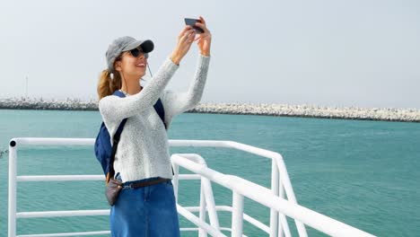 woman taking selfie with mobile phone while travelling in ferry 4k