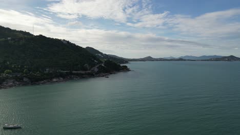 Flying-along-the-coastline-with-rocky-banks-and-bushy-landscape