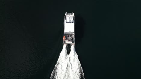 massive wakes being created when norwegian ferry transports passengers between docks in the beautiful fjord