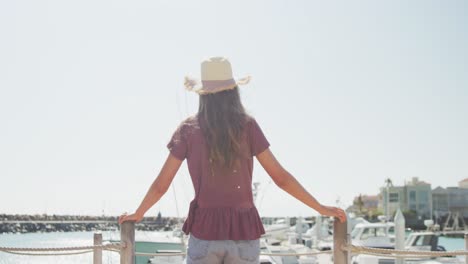 rear view of a teenage caucasian girl harbour side