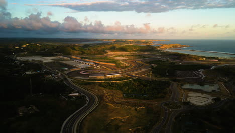 Kuta-Lombok,-Indonesia--Aerial-drone-forward-moving-shot-over-location-of-the-MotoGP-circuit-been-developed-in-Kuta-Lombok,-Indonesia-during-evening-time