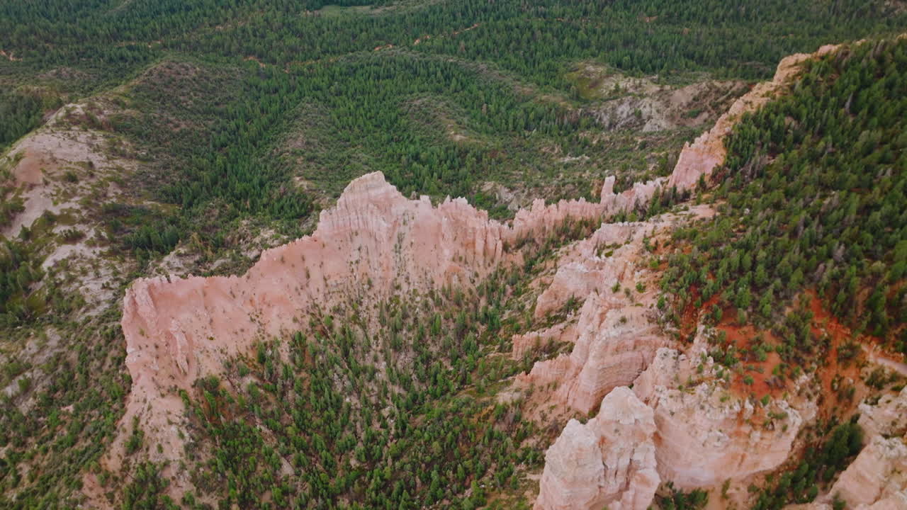 Sharpened tops of rocks in Bryce Canyon National Park. Pine forests covering the mountainous landscape. Top view.