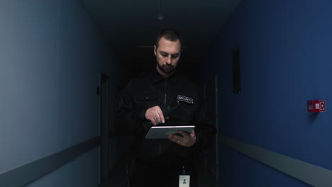 man holding tablet and flashlight