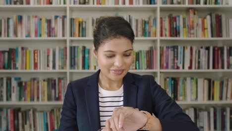 Portrait-young-woman-student-smiling-bookshelf-library-university