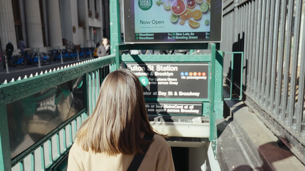 Woman Walking Down Subway Stairs in NYC